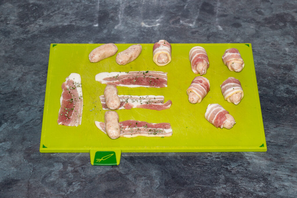 cocktail sausages being rolled in streaky bacon