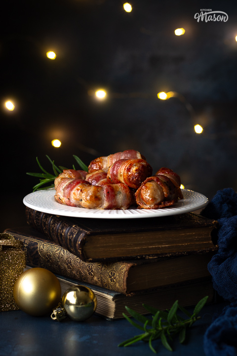 A plate of air fryer pigs in blankets on a stack of books