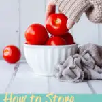 Someone taking a tomato from a bowl. A text overlay says 'how to store tomatoes'.