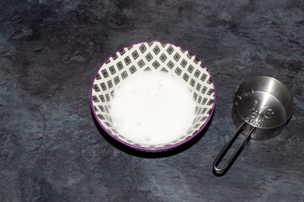 Baking powder and boiling water fizzing in a small bowl