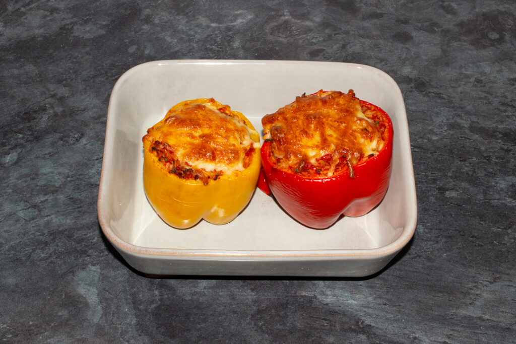 Cooked rice stuffed peppers in an oven dish