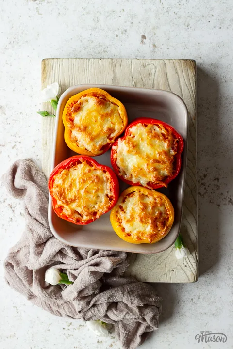 Baked rice stuffed peppers in an oven dish