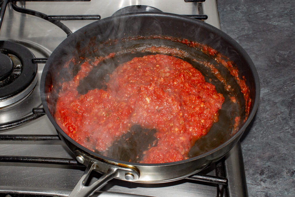 Thickened and reduced tomato sauce in a pan