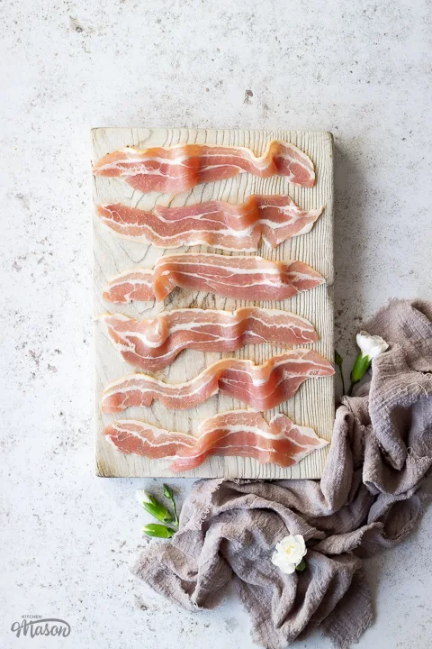 Streaky bacon on a chopping board