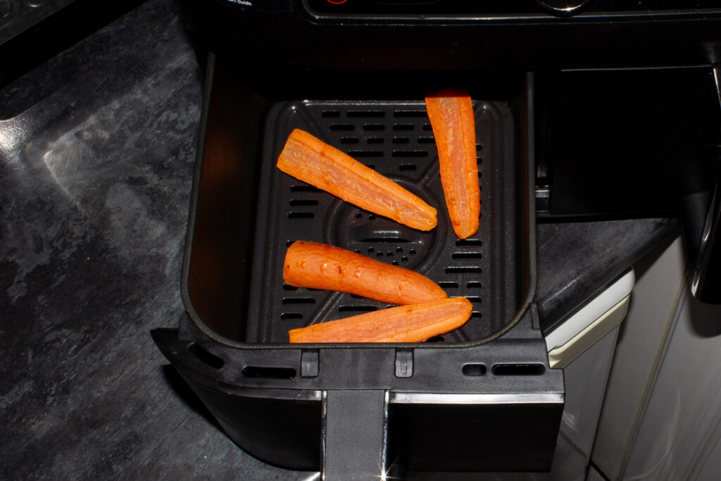 Part cooked carrot halves in an air fryer