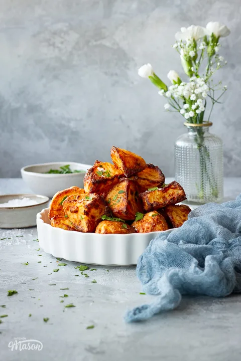 A dish of air fryer roast potatoes with a napkin