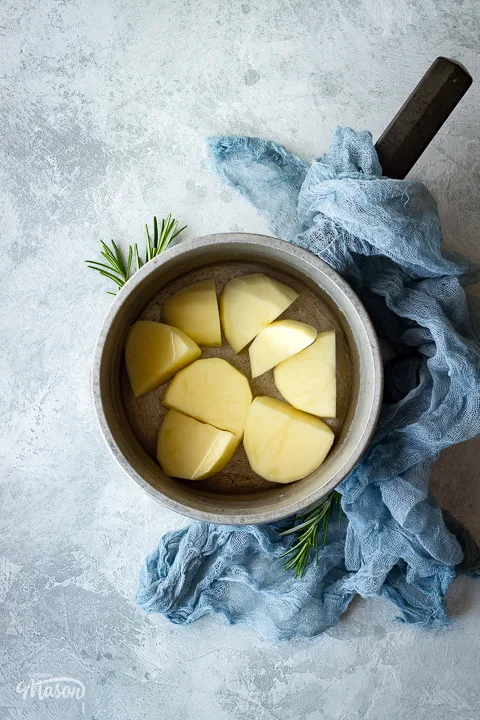 a saucepan with prepared potatoes