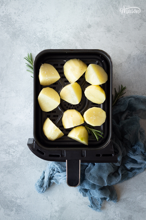 Prepped potatoes in an air fryer drawer
