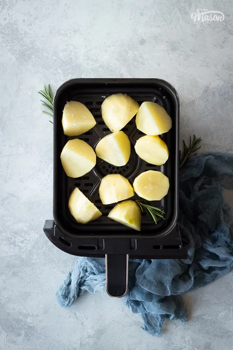 Prepped potatoes in an air fryer drawer