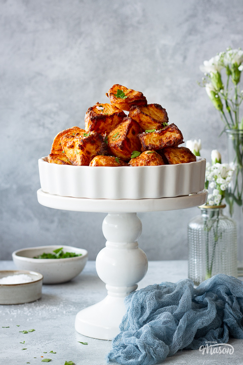 A pyramid of air fryer roast potatoes in a dish on a stand