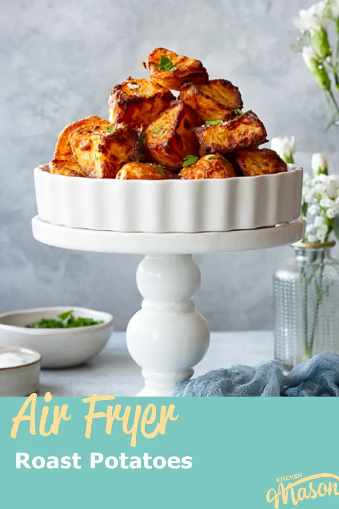 A pyramid of air fryer roast potatoes in a dish on a stand. A text overlay says' Air Fryer Roast Potatoes'.
