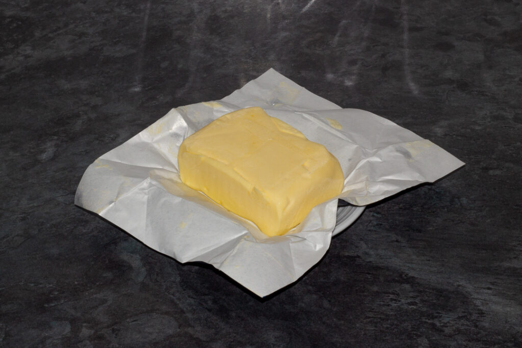 A block of butter on a kitchen worktop