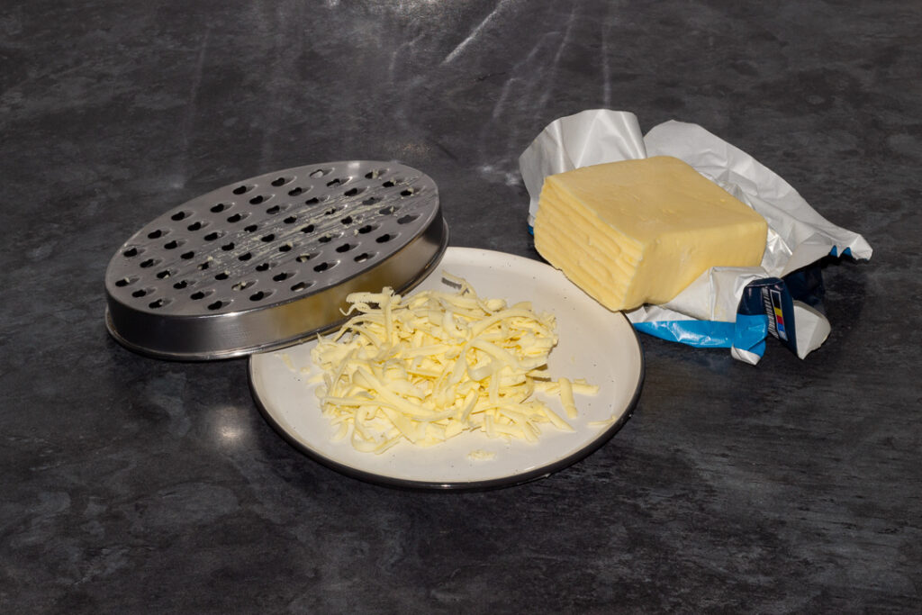 Grated butter on a plate with a grater