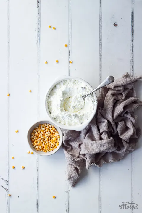 Corn flour and corn kernels in small bowls