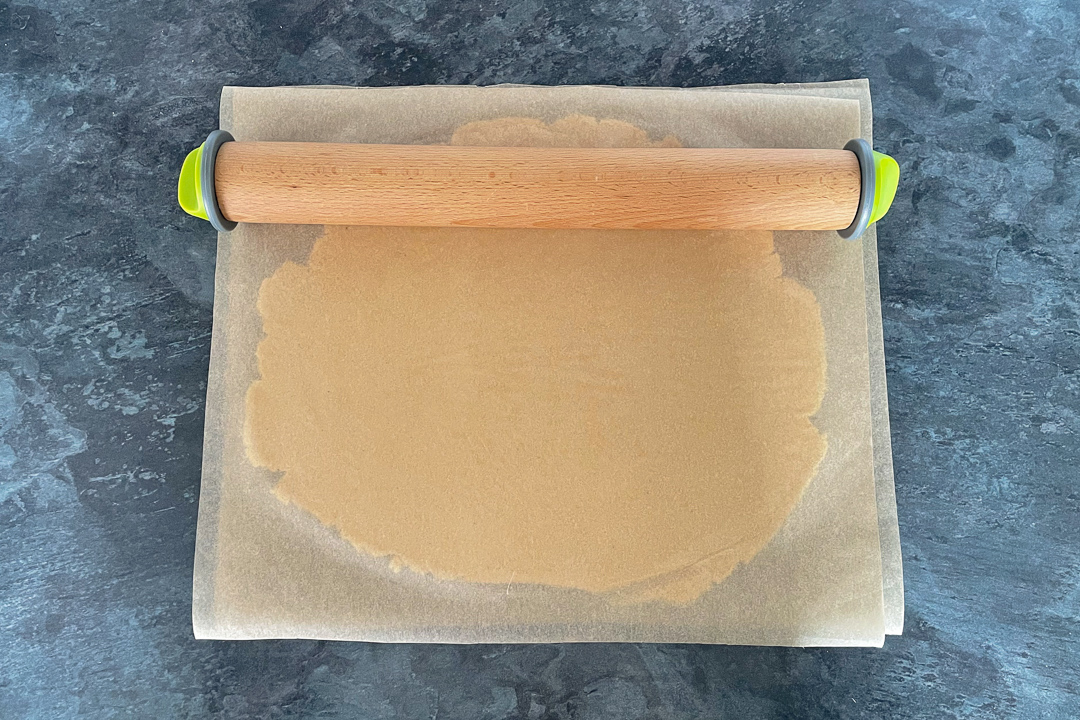 cookie dough rolled out between baking paper
