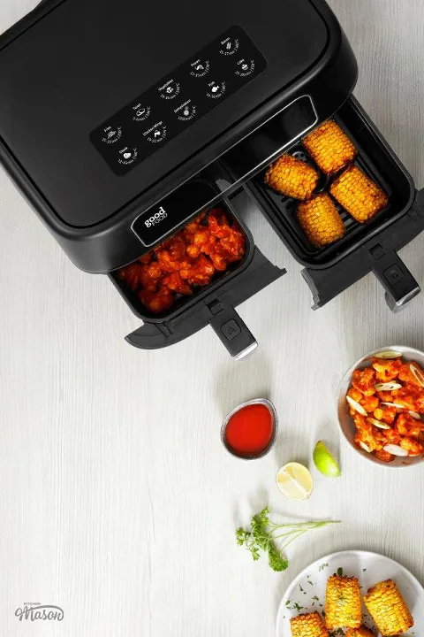 Food in the drawers of a Tower GoodFood duo air fryer with bowls at the side.