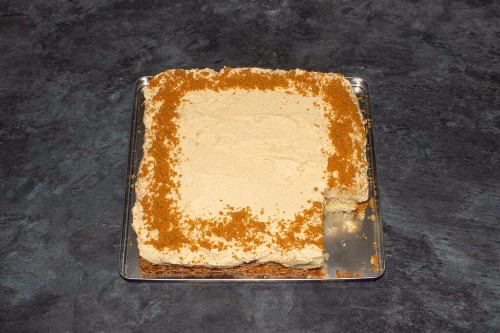 Decorated Biscoff traybake cake on a metal tray