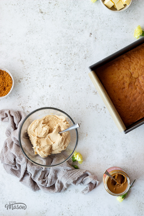 A cake in a tin and Biscoff frosting in a bowl