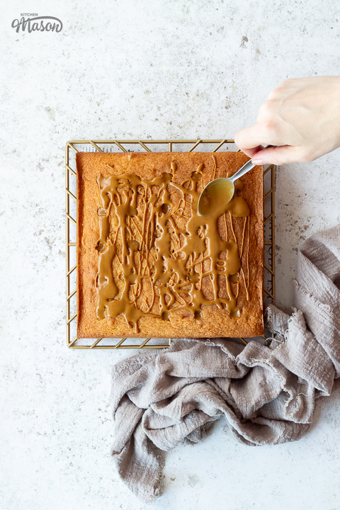 Biscoff spread being smoothed over a cake