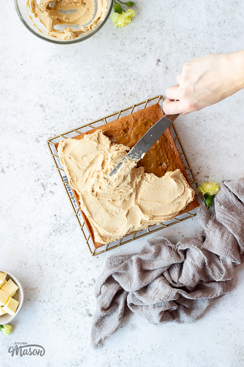 Biscoff frosting being spread over a cake