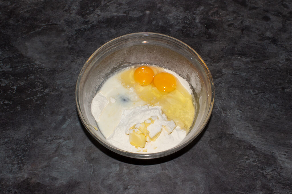 Biscoff cake ingredients in a glass mixing bowl