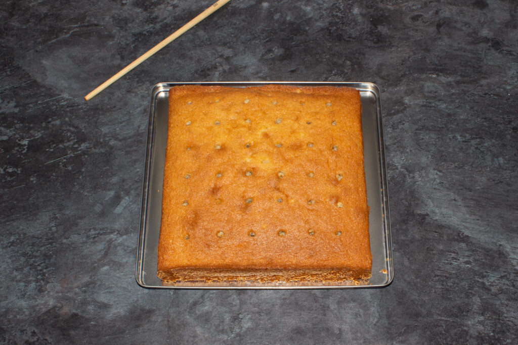 A sponge cake with holes poked into it