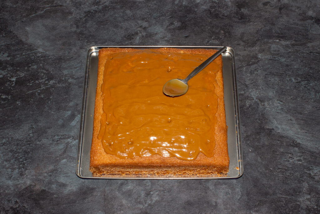 Melted Biscoff spread on top of a cake