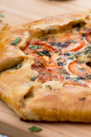 A tomato galette on a wooden board