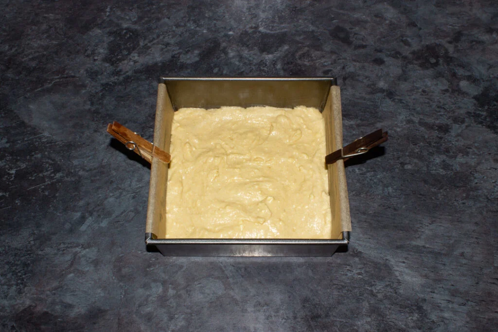 Cake batter in a lined tin.