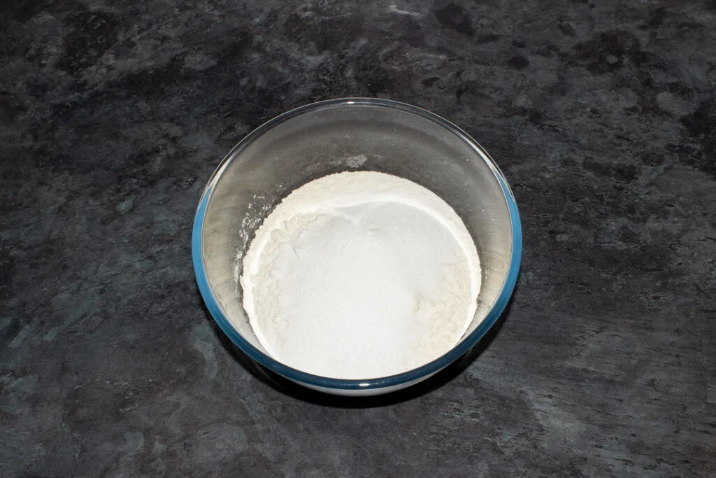 Flour, baking powder and sugar in a glass bowl