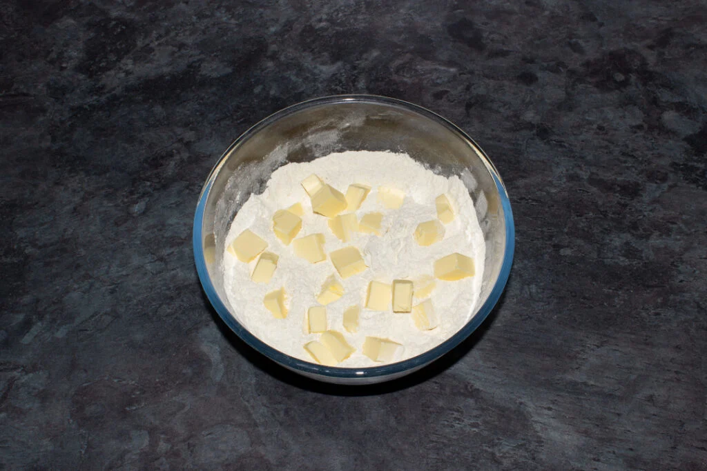 Flour, baking powder, sugar and cubed butter in a large mixing bowl