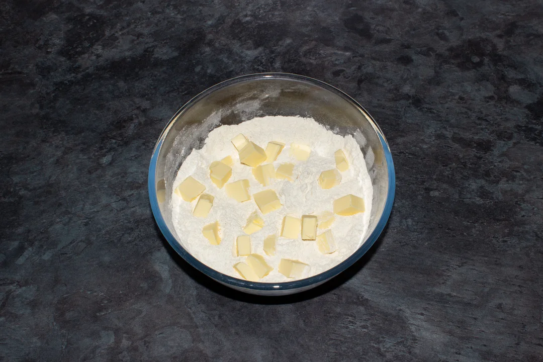 Flour, baking powder, sugar and cubed butter in a large mixing bowl