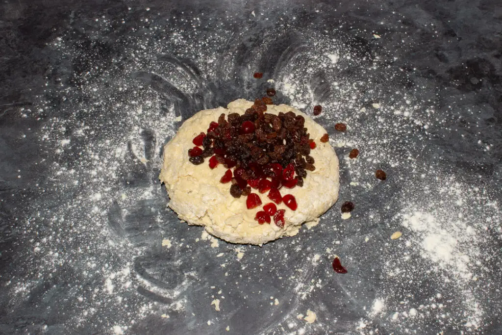 Fried fruit being added into scone dough