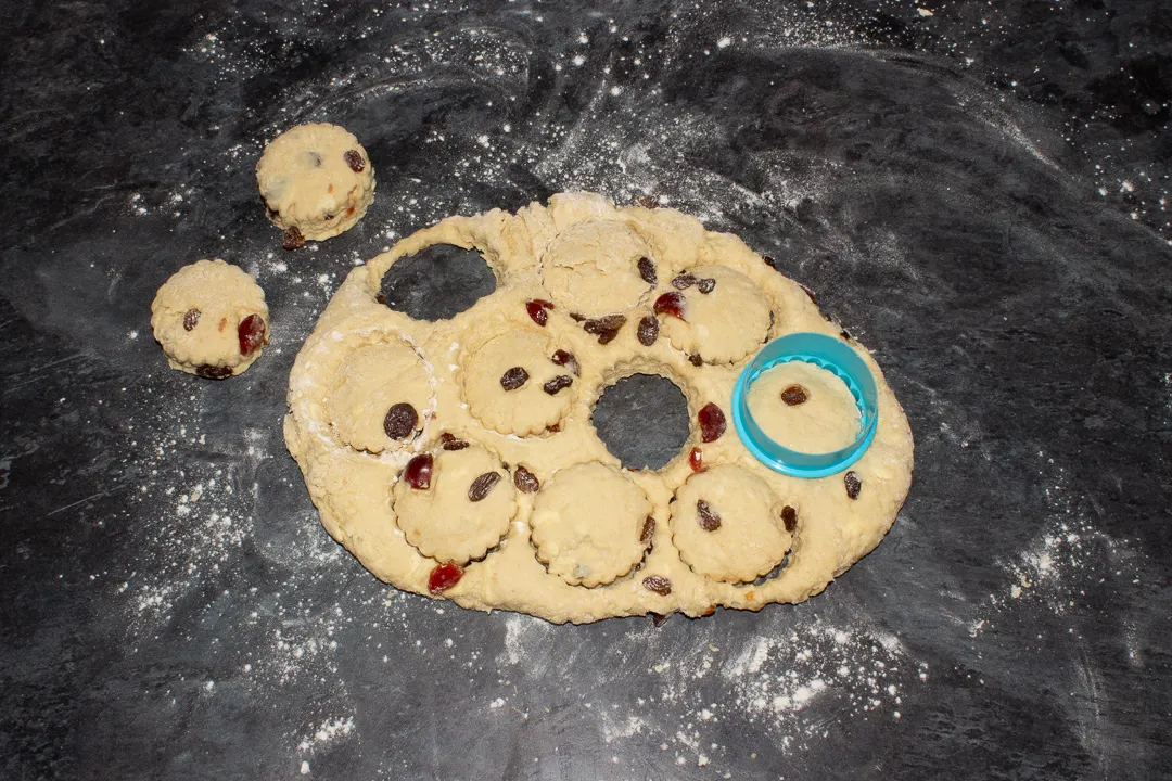 Scones being cut out of dough with a cutter