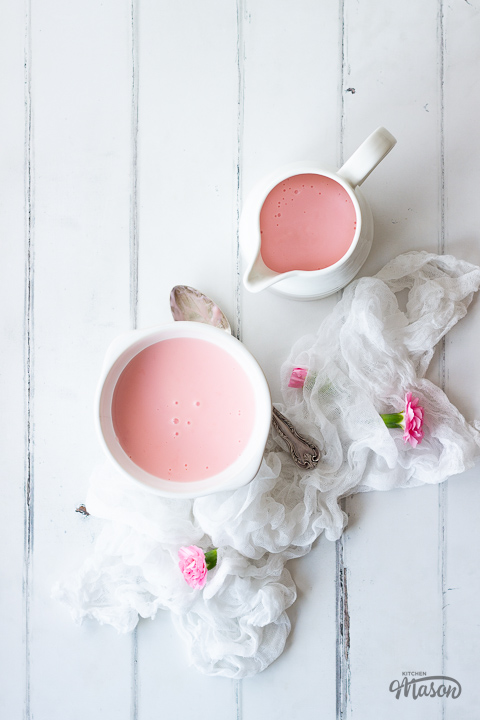 Pink custard in a jug and bowl