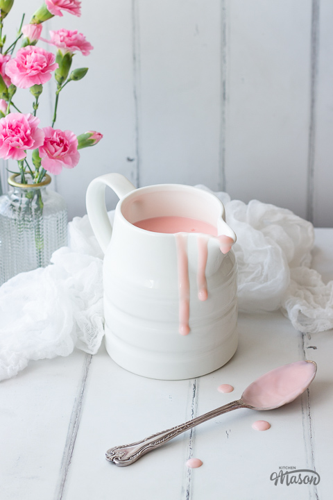 Pink custard in a white jug