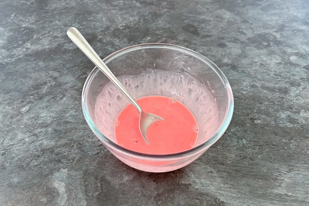 Strawberry blancmange paste in a bowl