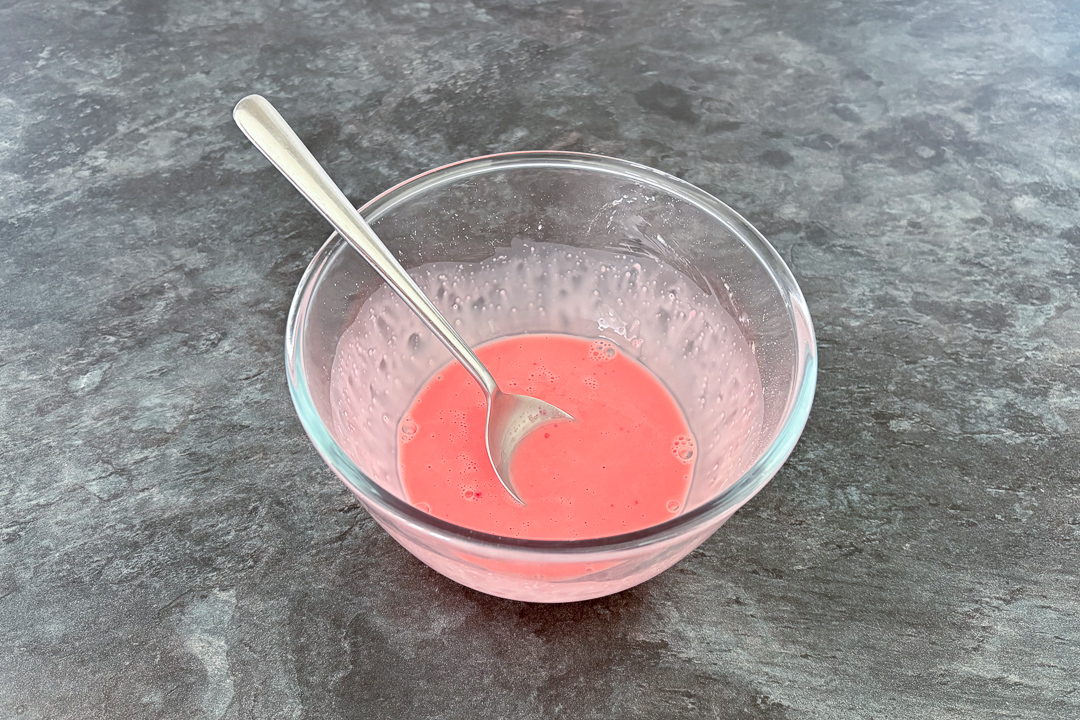 Strawberry blancmange paste in a bowl