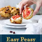 Someone picking up a fruit scone with jam and clotted cream on it. A text overlay says 'Easy peasy fruit scones'