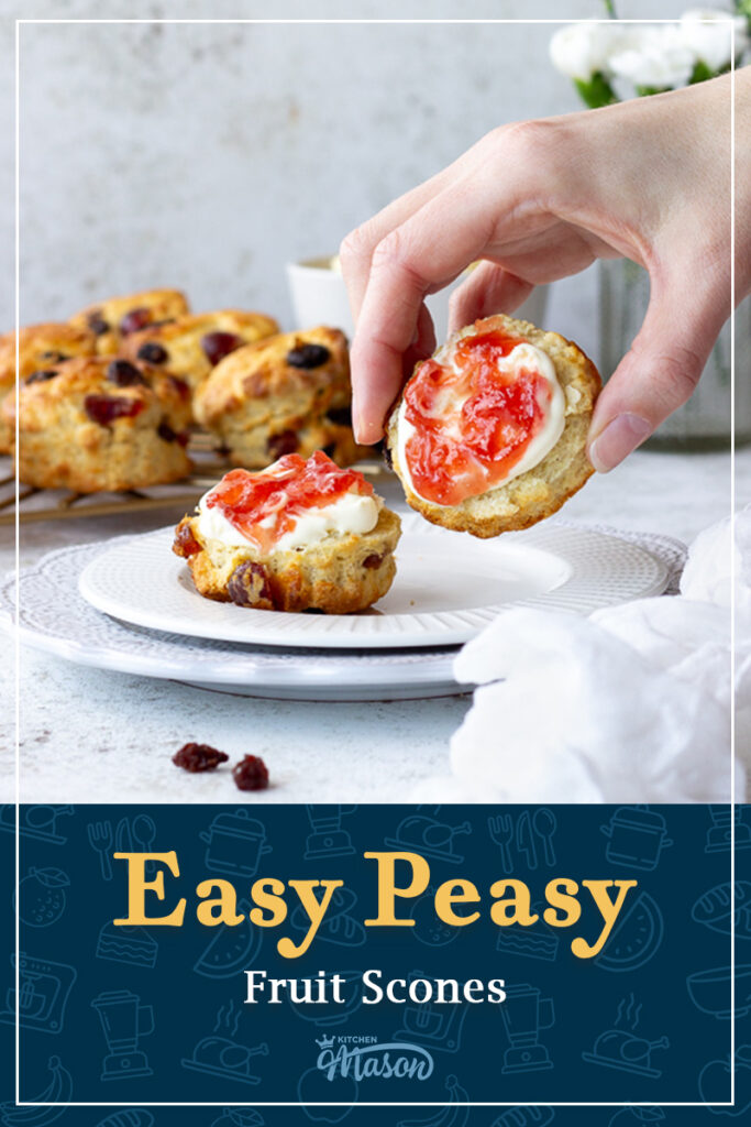 Someone picking up a fruit scone with jam and clotted cream on it. A text overlay says 'Easy peasy fruit scones'