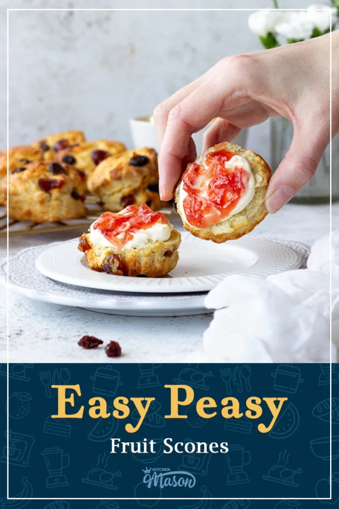 Someone picking up a fruit scone with jam and clotted cream on it. A text overlay says 'Easy peasy fruit scones'