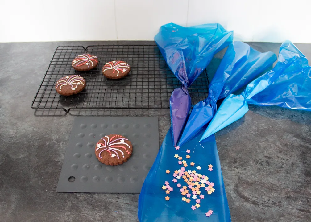 Sugar stars being stuck onto firework biscuits.