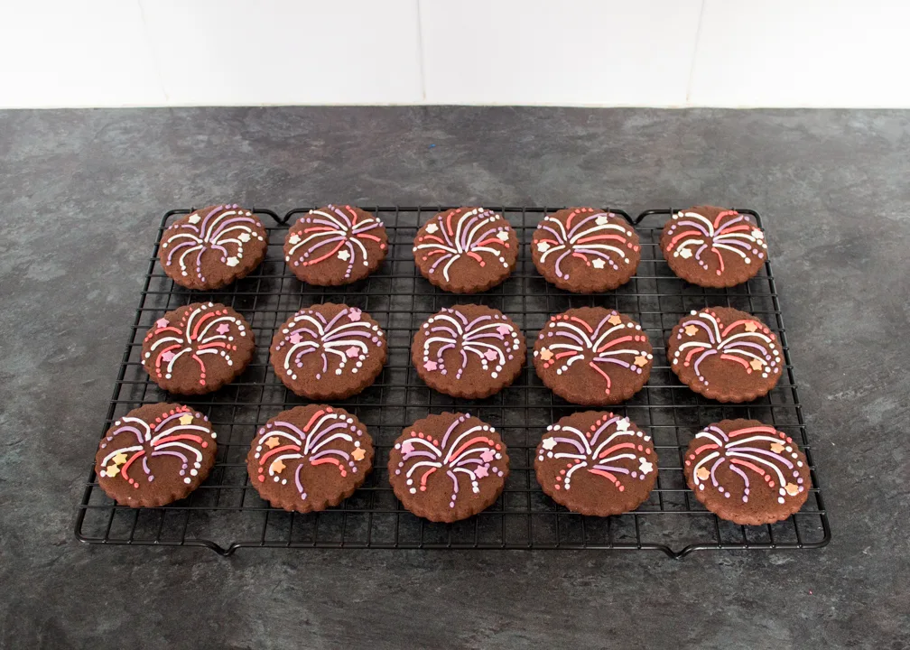 Firework biscuits setting on a cooling rack.