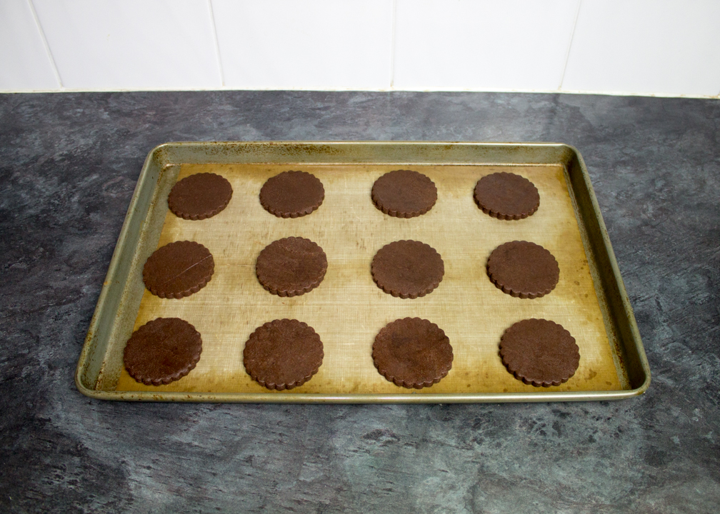 Unbaked firework biscuits on a lined baking tray.