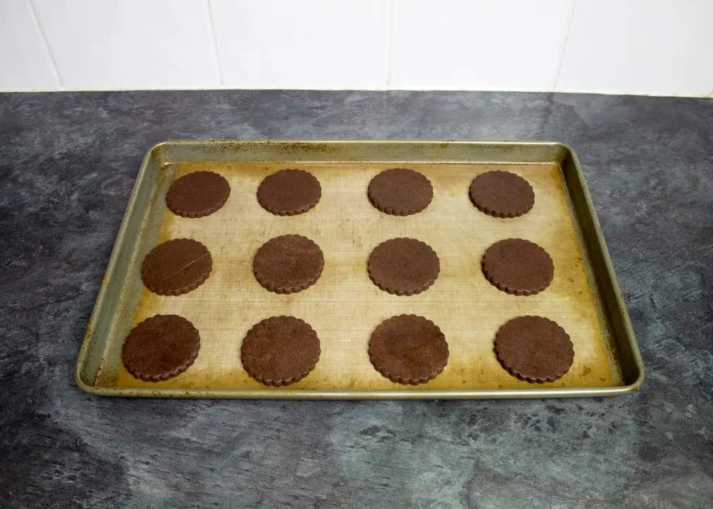 Unbaked firework biscuits on a lined baking tray.