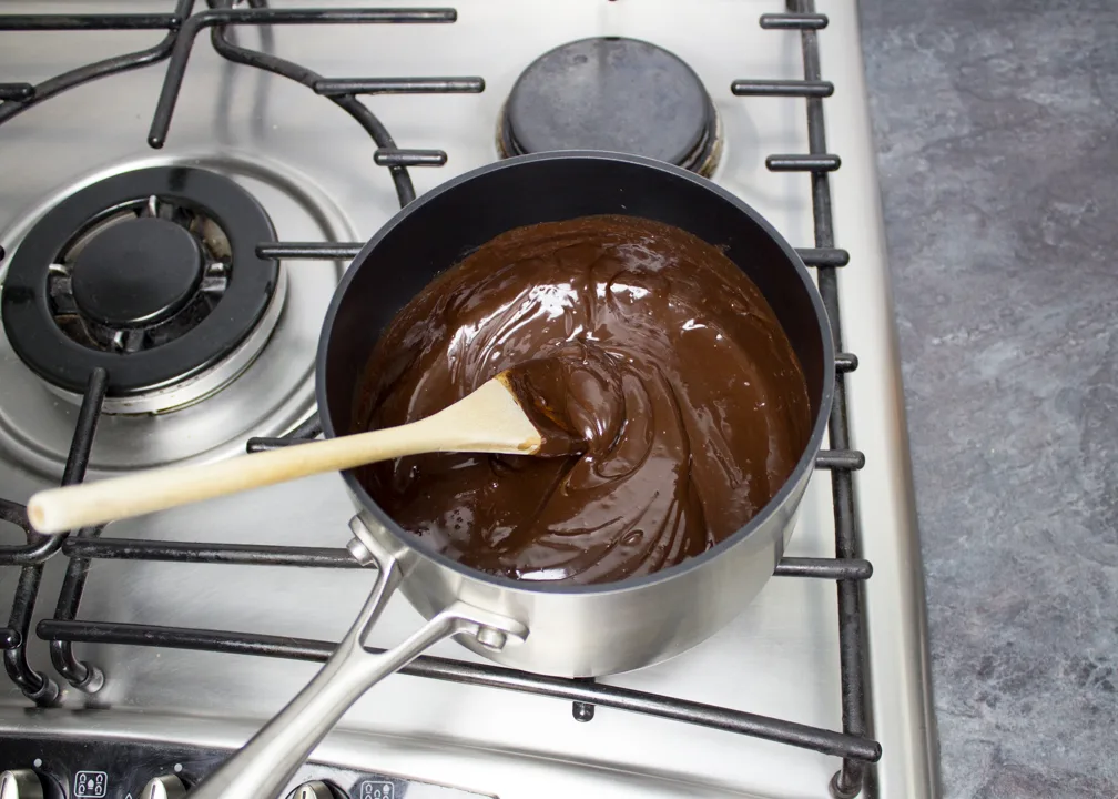Chocolate sauce with added butter, vanilla and salt, in a saucepan over a low heat.