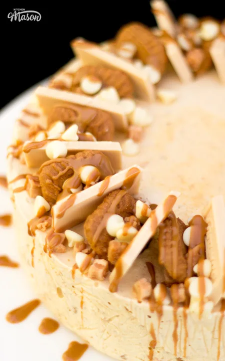 A Biscoff ice cream cake topped with Biscoff biscuits, blonde chocolate and melted Biscoff spread.