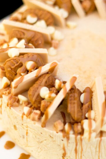 A Biscoff ice cream cake on a white serving plate.