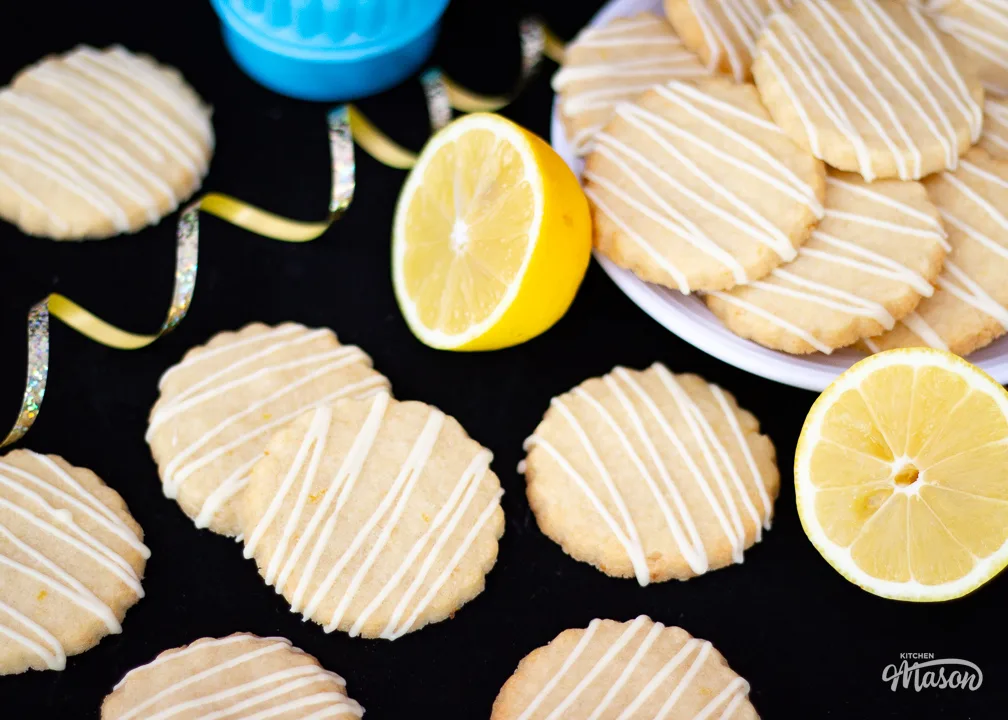 Lemon biscuits on a plate with a cookie cutter next to it.