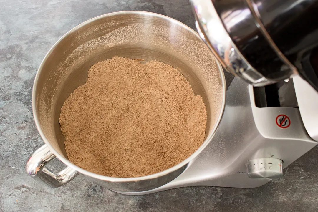 Dry chocolate cupcake ingredients mixed together in an electric stand mixer.